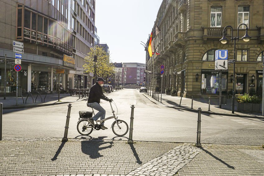 Old Man Riding Bicycle on Empty Street in Frankfurt During Lockdown